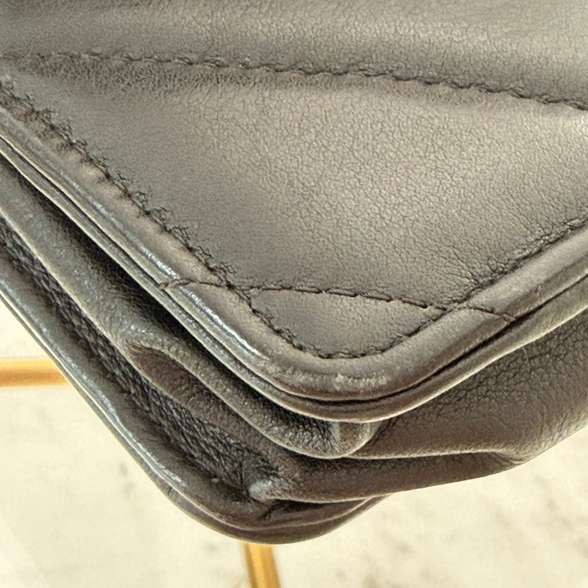 Wear of the corner of the Chanel CC bag with turn-lock closure on quilted leather available in Cyprus