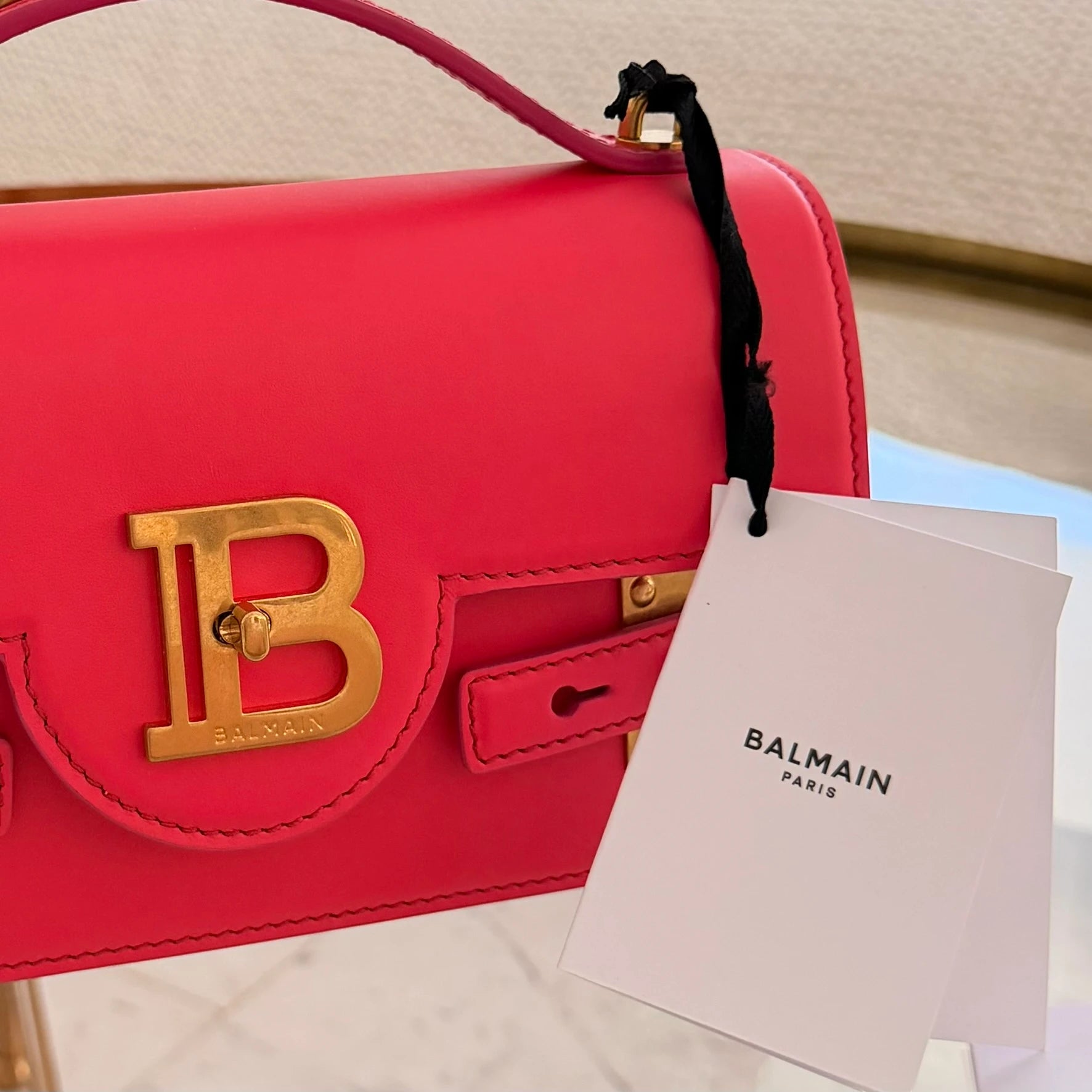 Balmain | 24 B-Buzz leather crossbody bag in Pink