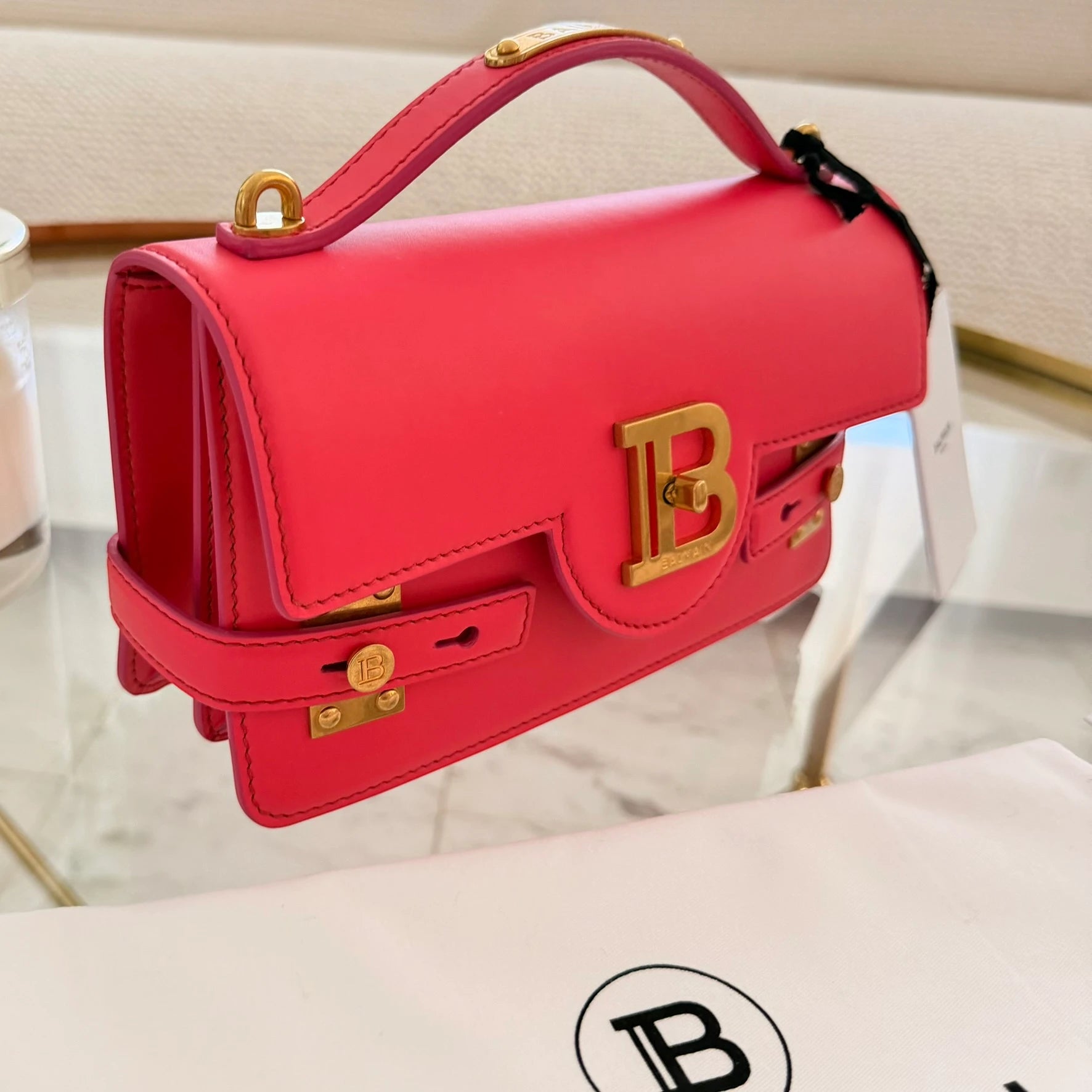 Balmain | 24 B-Buzz leather crossbody bag in Pink
