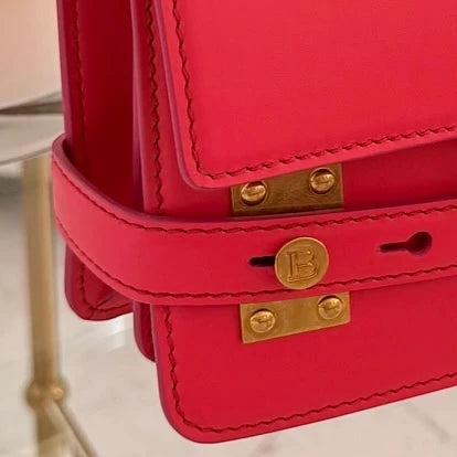 Balmain | 24 B-Buzz leather crossbody bag in Pink