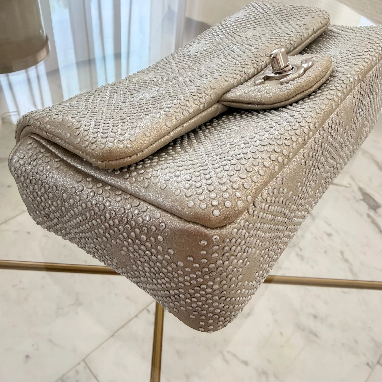 Chanel iridescent studded calfskin Mini Flap crossbody bag, with a chain strap and silver hardware available in Cyprus at HOUSE of MICY